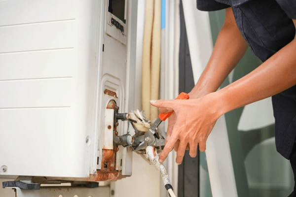 technician repairing outdoor air conditioner 600nw 2634668179